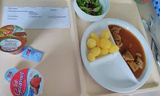 Ein Teller mit einer Mahlzeit, bestehend aus Fleisch, Kartoffeln und Soße.